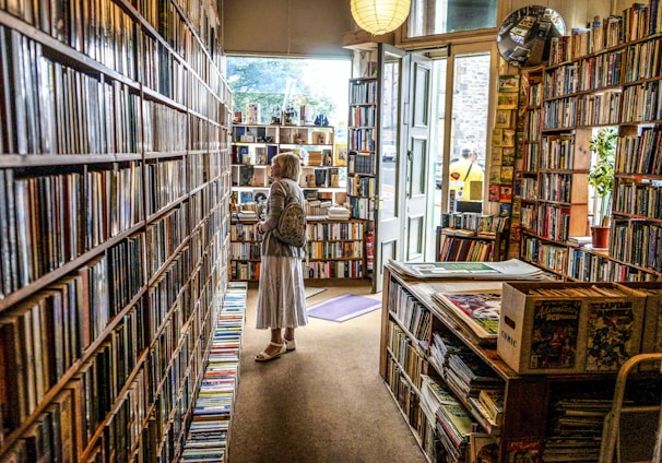 woman inside library looking at books