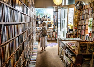 woman inside library looking at books