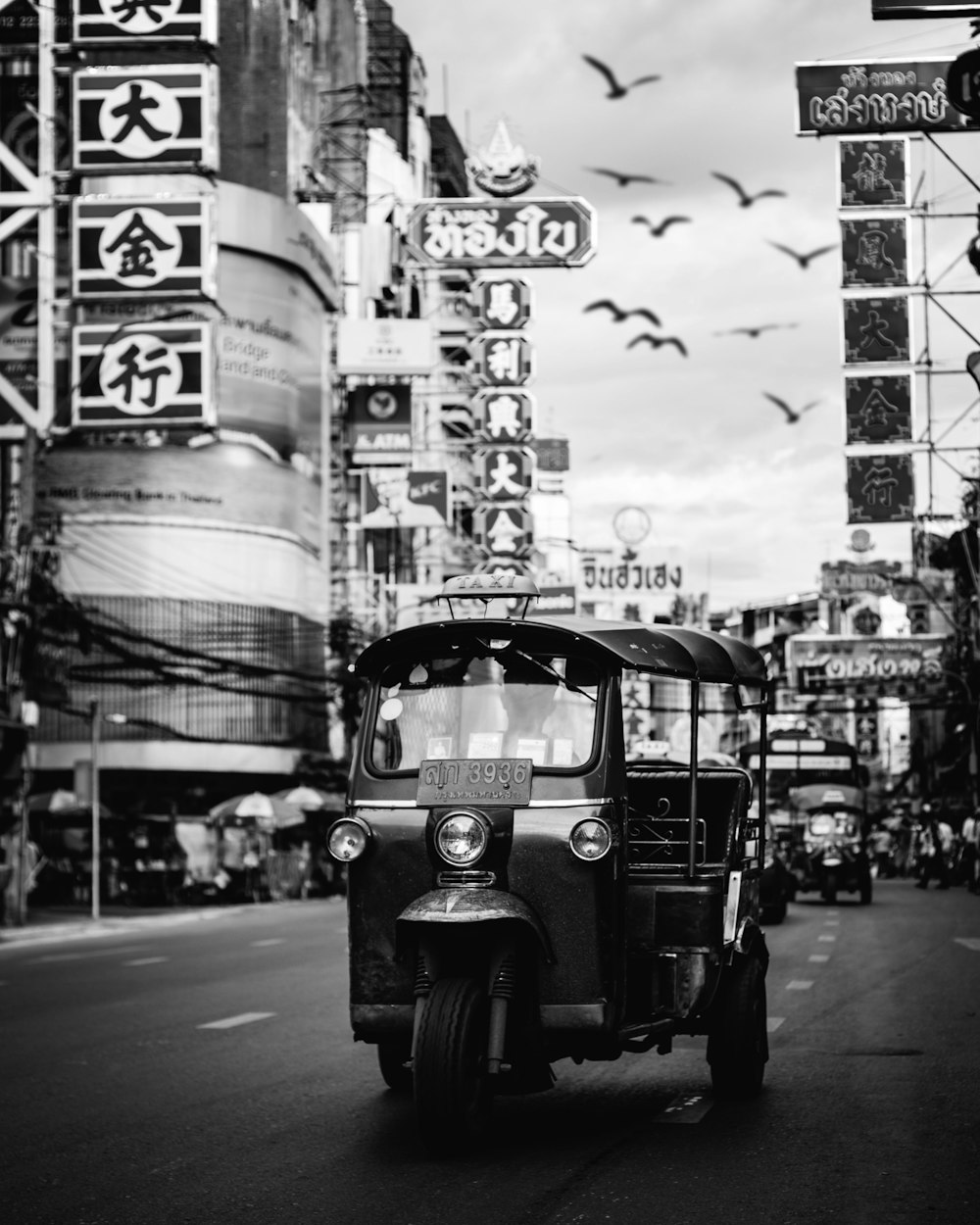 gray auto rickshaw on road