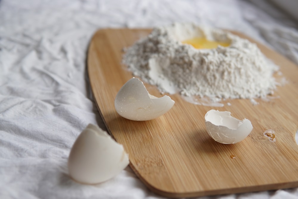 œuf concassé sur planche à découper et farine