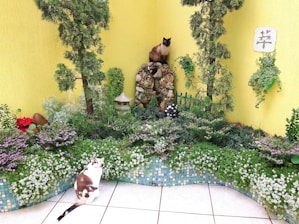 A serene garden with lush greenery and a secure enclosure for cats to enjoy.