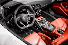 closeup photography of red and black Audi vehicle interior