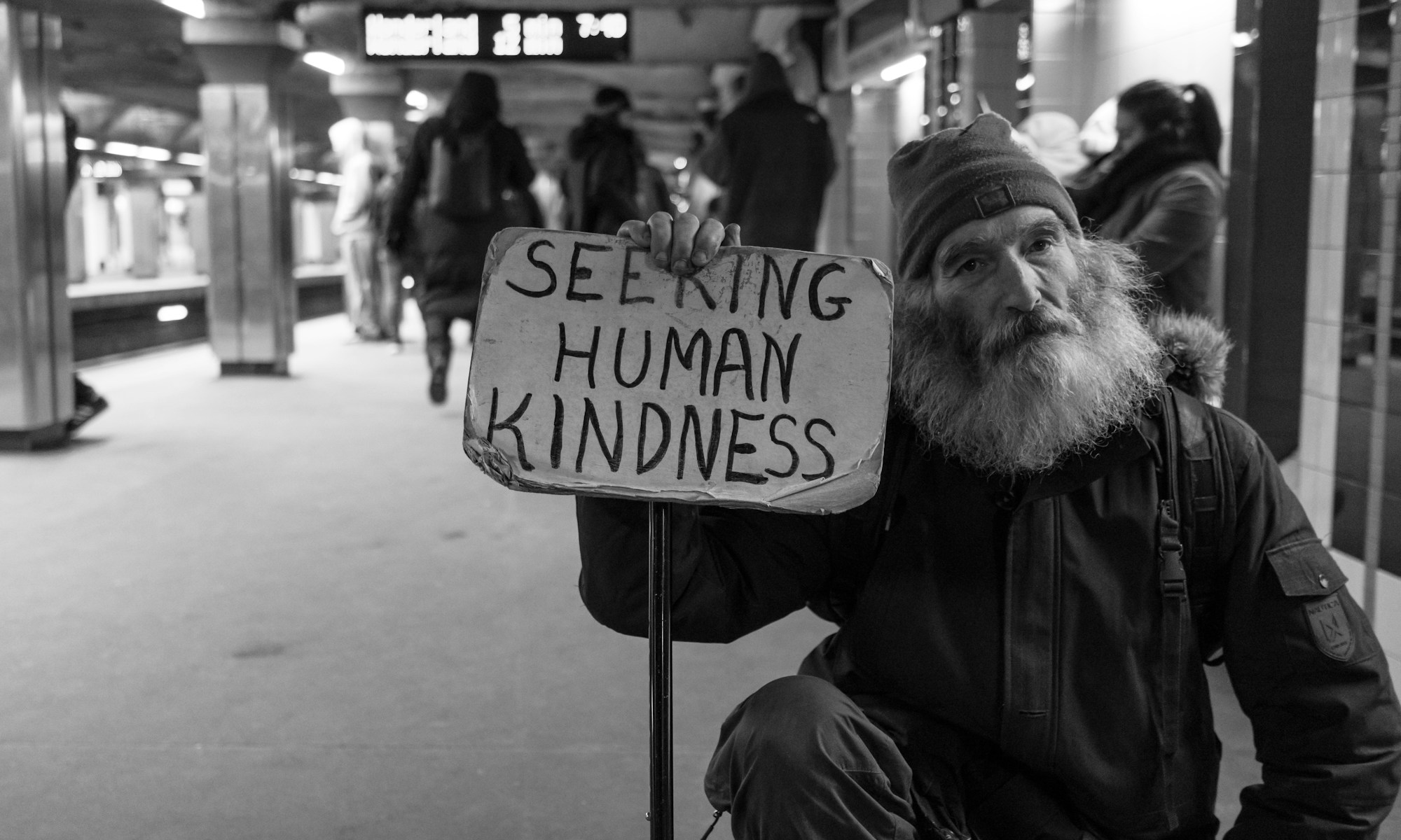 Help the homeless. man holding card with seeking human kindness text