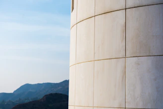 Modern photo of the restored Associação da Covilhã building with Serra da Estrela mountains in the background.