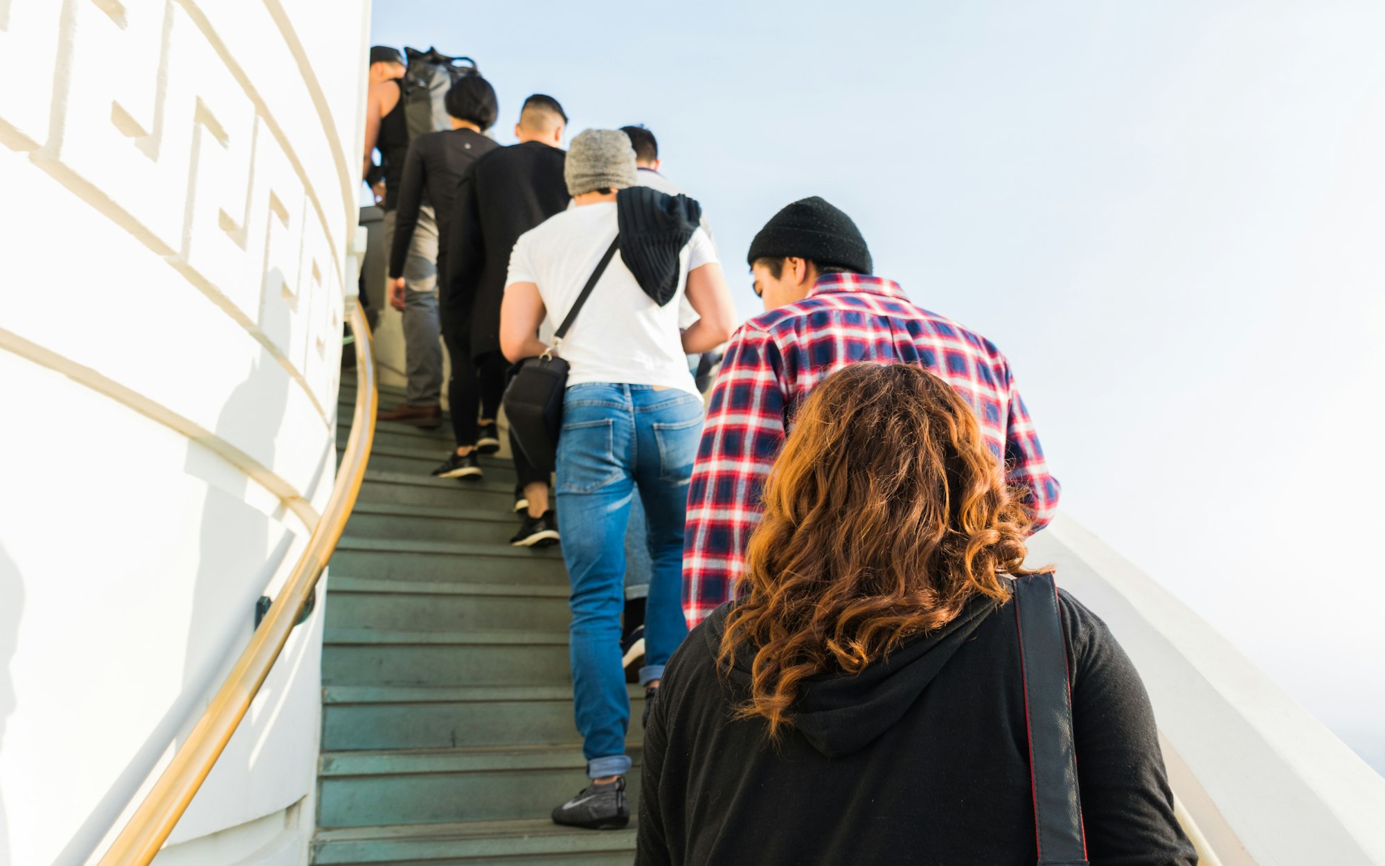 people climbing a spiral staircase