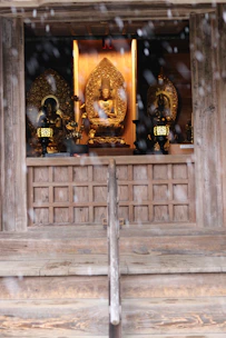 A serene temple altar displaying handcrafted spiritual keepsakes bathed in soft golden light