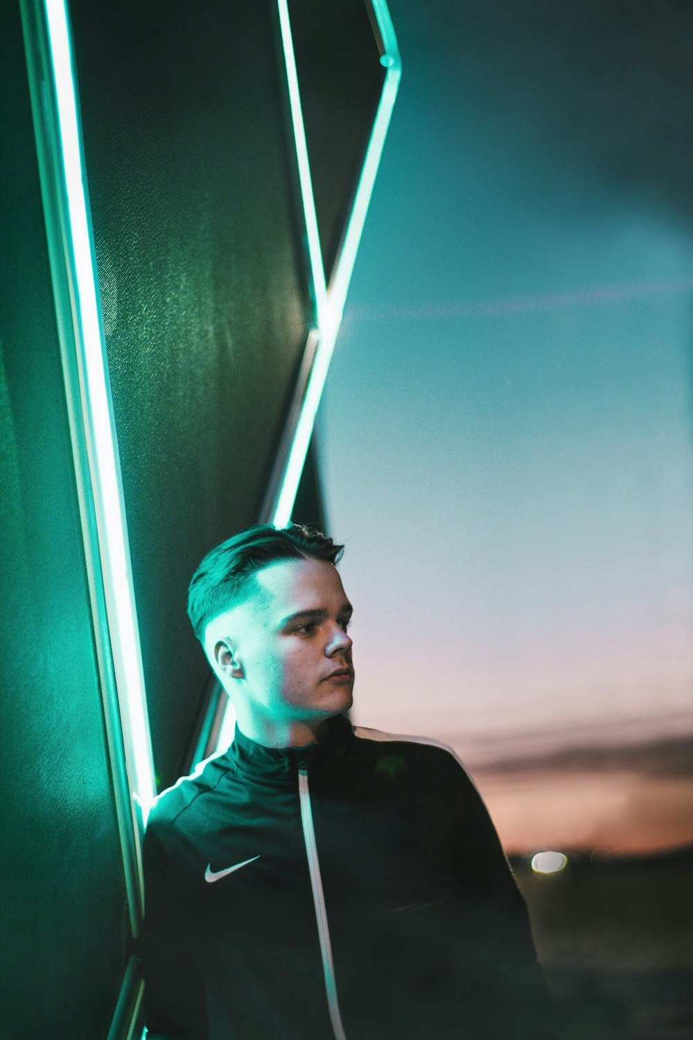 man standing near neon signage