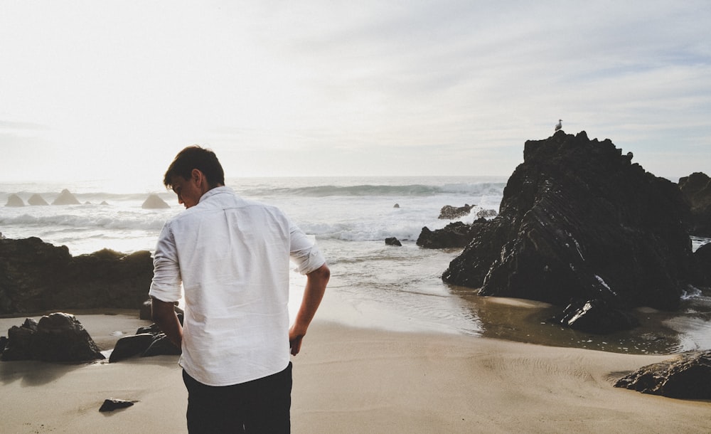 man standing on seashore