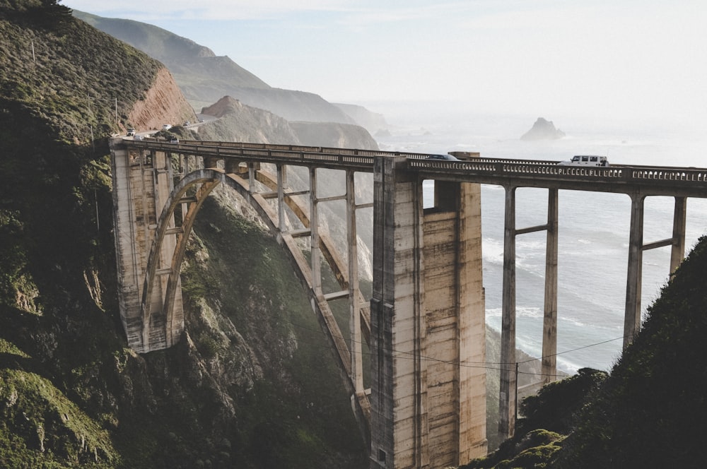 cars on concrete bridge during day