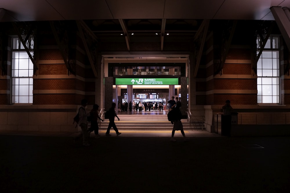 people walking near brown building