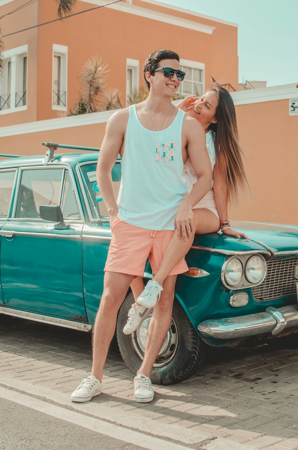 man and woman sitting on car