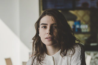 portrait photography of woman wearing knitted top