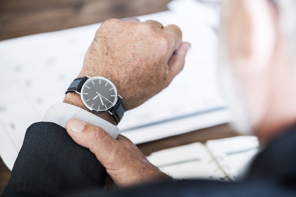 man wearing round watch at 9:36