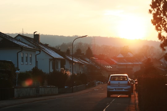 car passing through houses during golden hour in Steinau an der Straße Germany