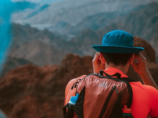 man wearing backpack facing the mountains during day in Eilat Israel