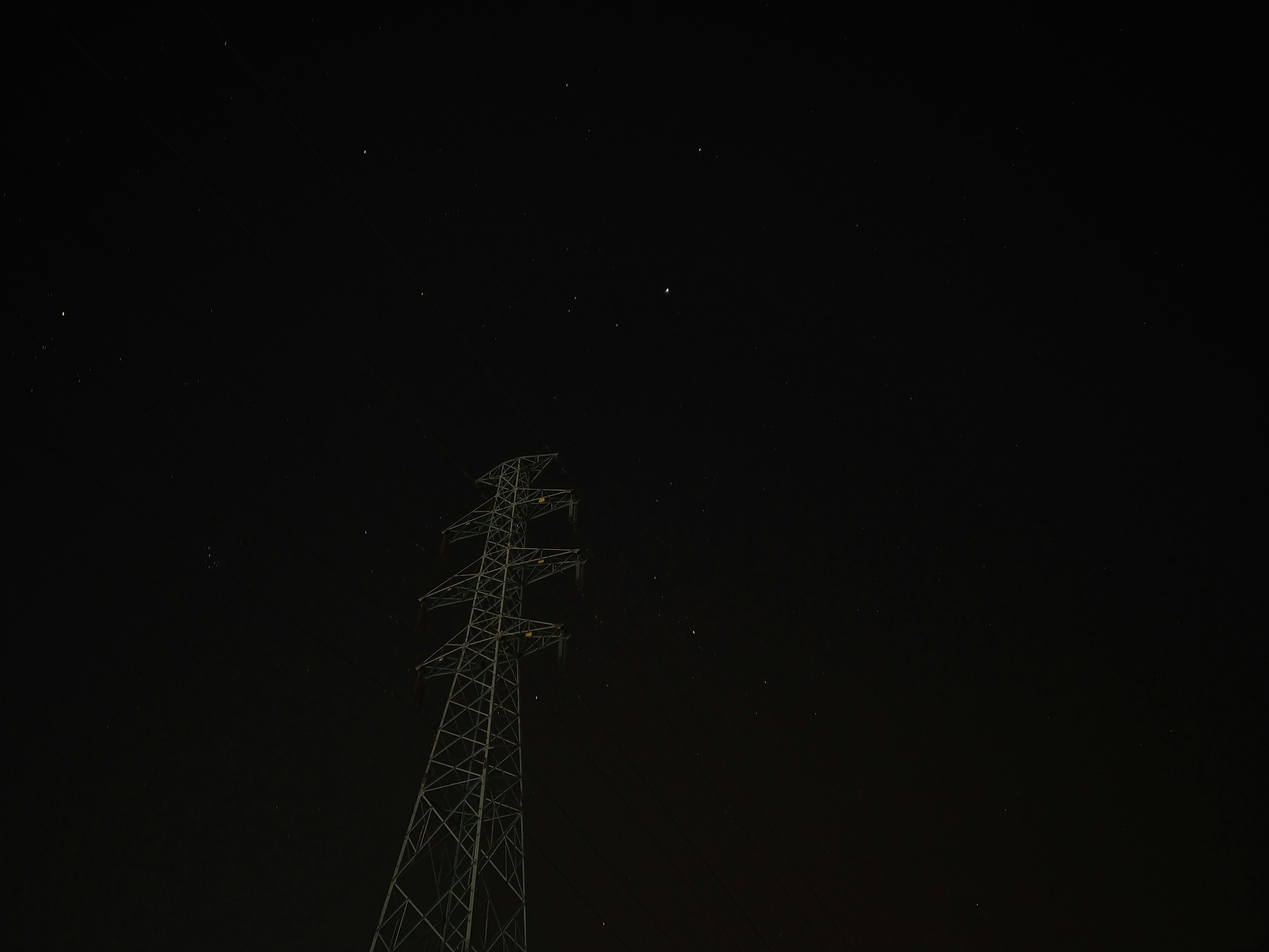 High-voltage tower under the night sky