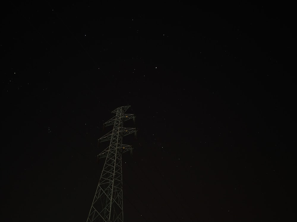 a radio tower at night with stars in the sky