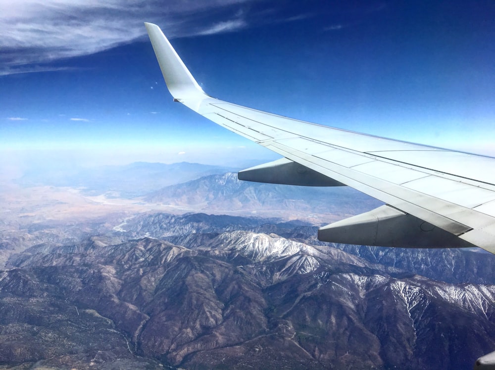 aerial photography of gray mountain in airplane window shot