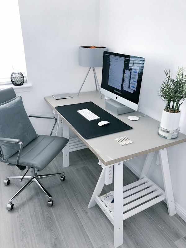 Clean modern home office with wood desk and shelf