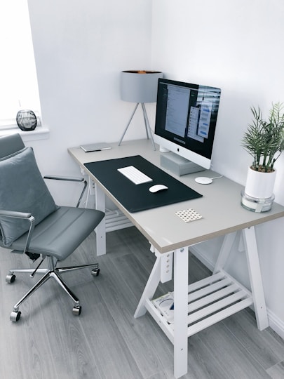 Clean minimal standing desk setup with dual monitors and organized workspace