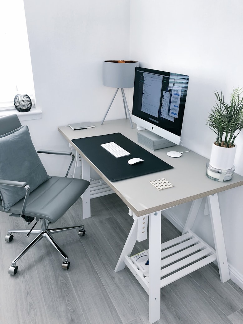 calm and productive workspace — minimal clean desk with only essential items and warm lighting