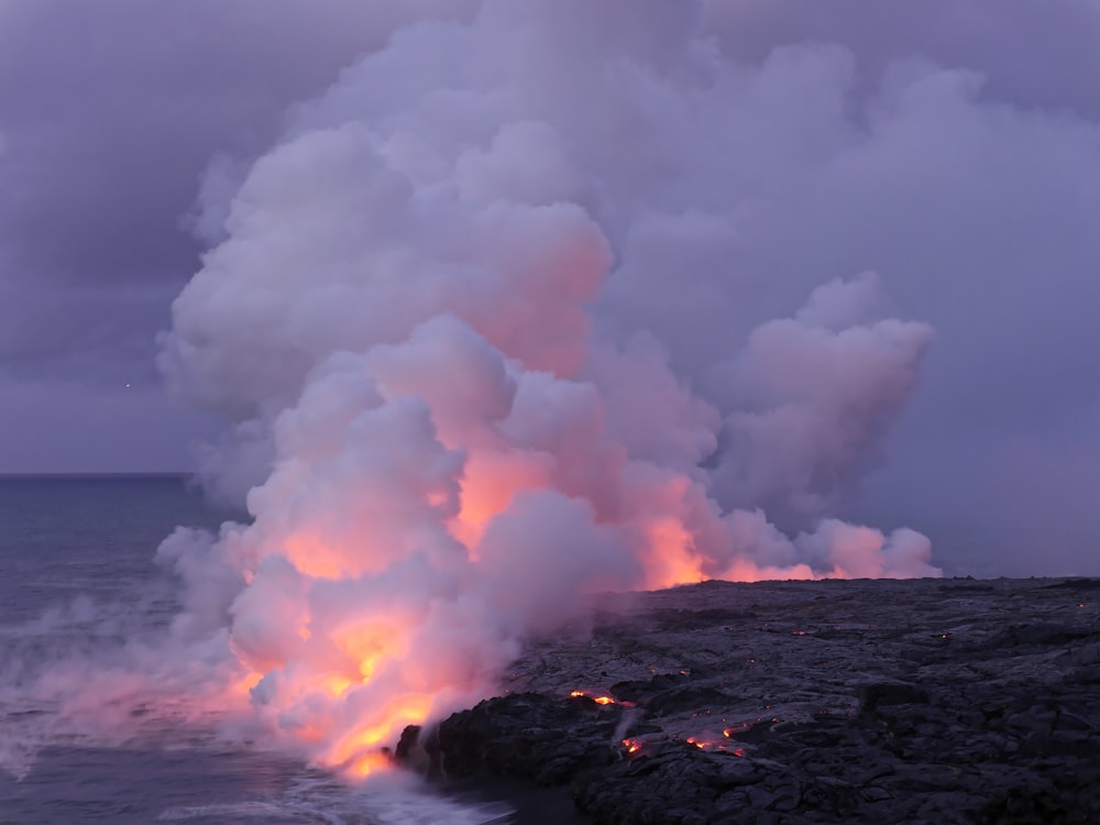 hill burned near ocean under white sky