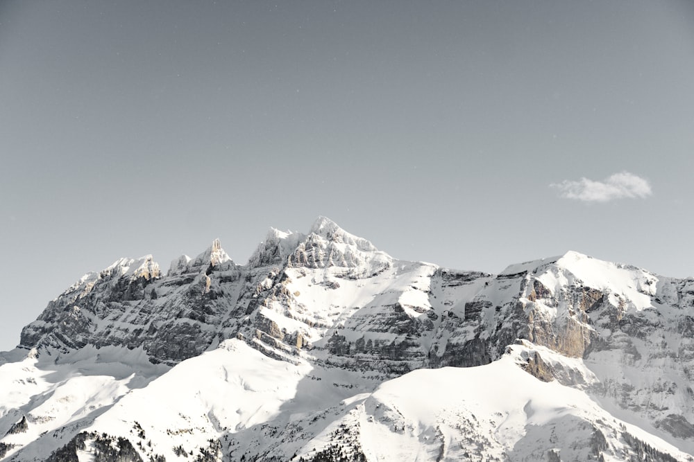 snow covered by mountain during daytime