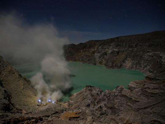 aerial view of mountain and body of water during daytime in Ijen Indonesia