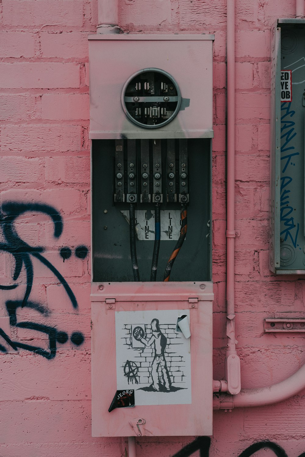 photography of distribution board with graffiti sticker