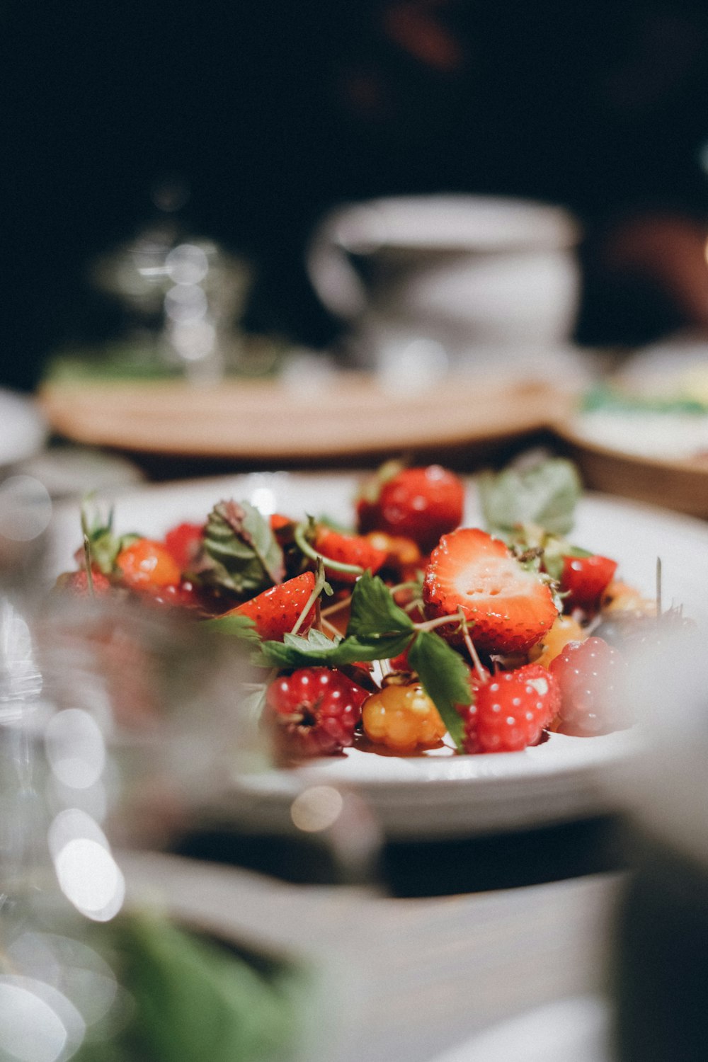 strawberries served on white ceramic plate