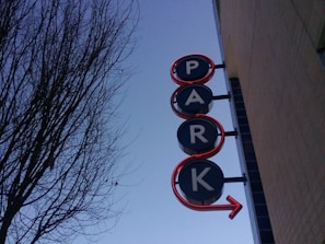 Technician carefully installing a monolith sign at the entrance of a business park.