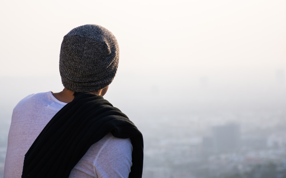 man looking high rise buildings