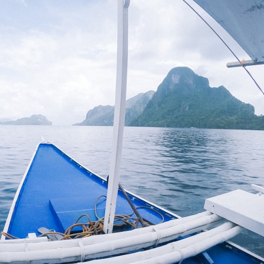 blue boat near islands in El Nido Philippines