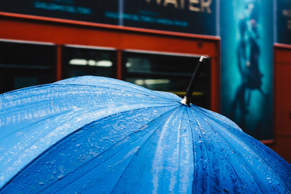 selective focus photography of blue umbrella
