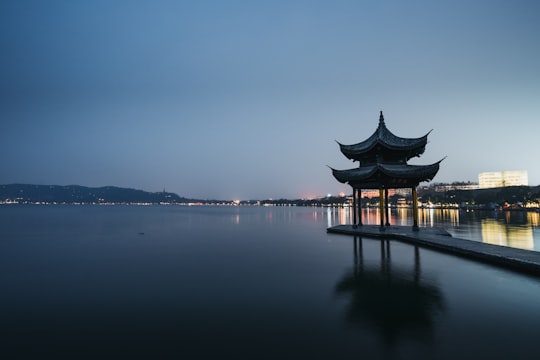 gray pier on body of water in West Lake China