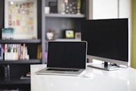 A modern workspace with a laptop and training materials on the desk.