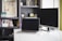 A modern workspace featuring a laptop and monitor on a white desk. The background includes a bookshelf filled with books and decorative items.