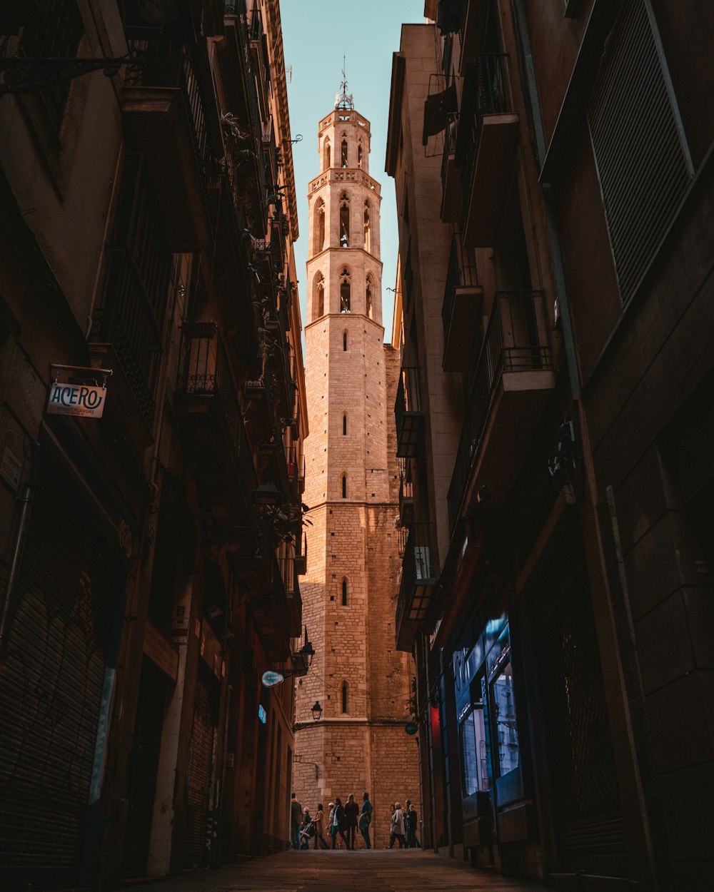 people standing between building