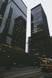 two black city buildings during daytime in time lapse photography