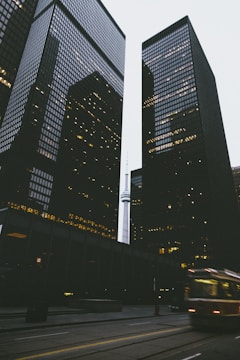 two black city buildings during daytime in time lapse photography