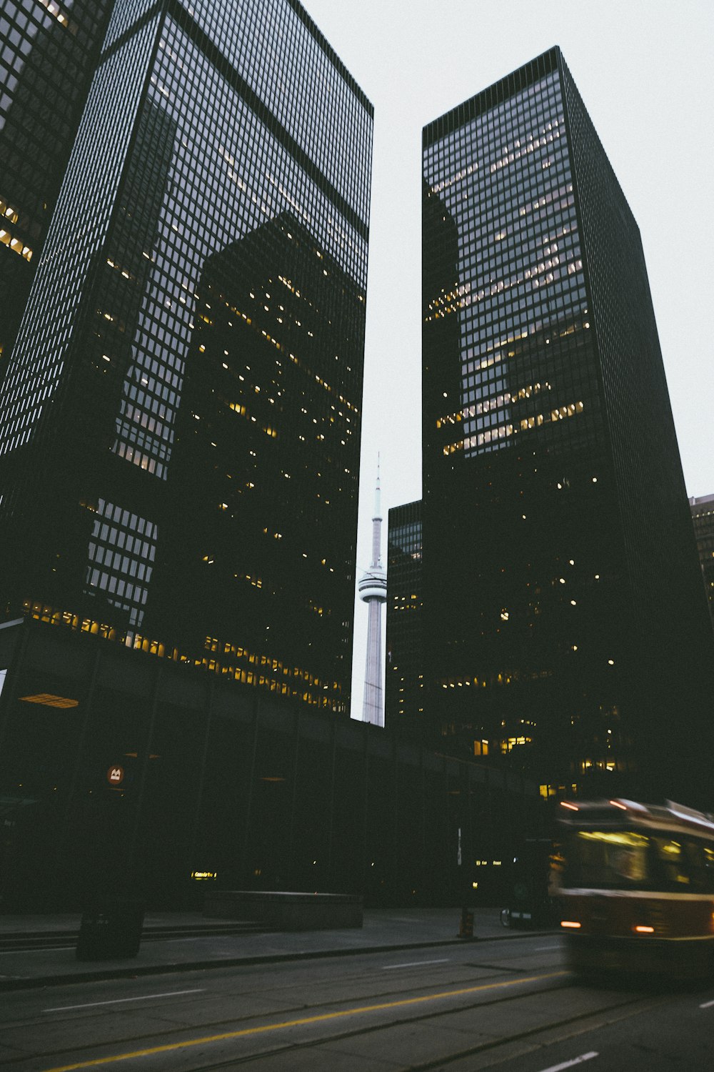 two black city buildings during daytime in time lapse photography