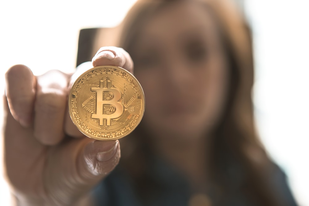 woman holding Bitcoin