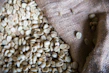 Artistic shot of roasted coffee beans spilling from a burlap sack.
