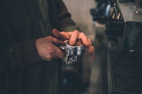 person holding cup with coffee