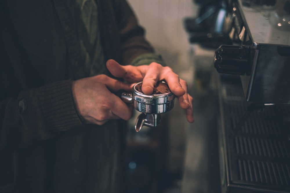 person holding cup with coffee