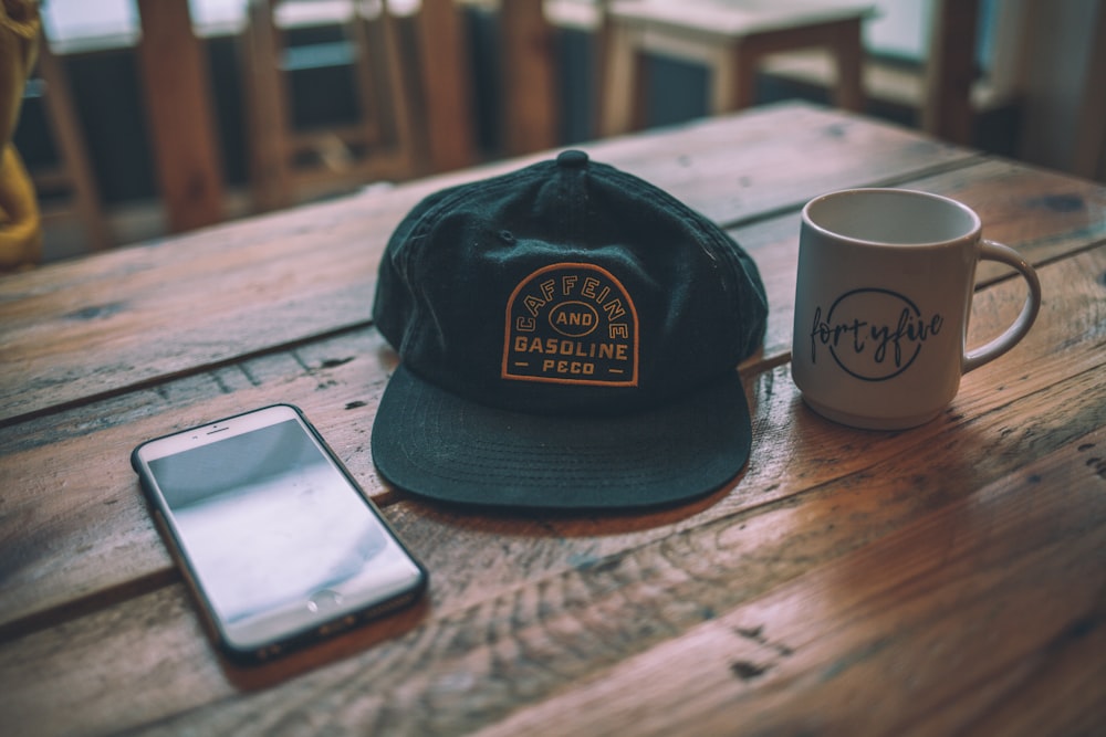 black cap beside mug