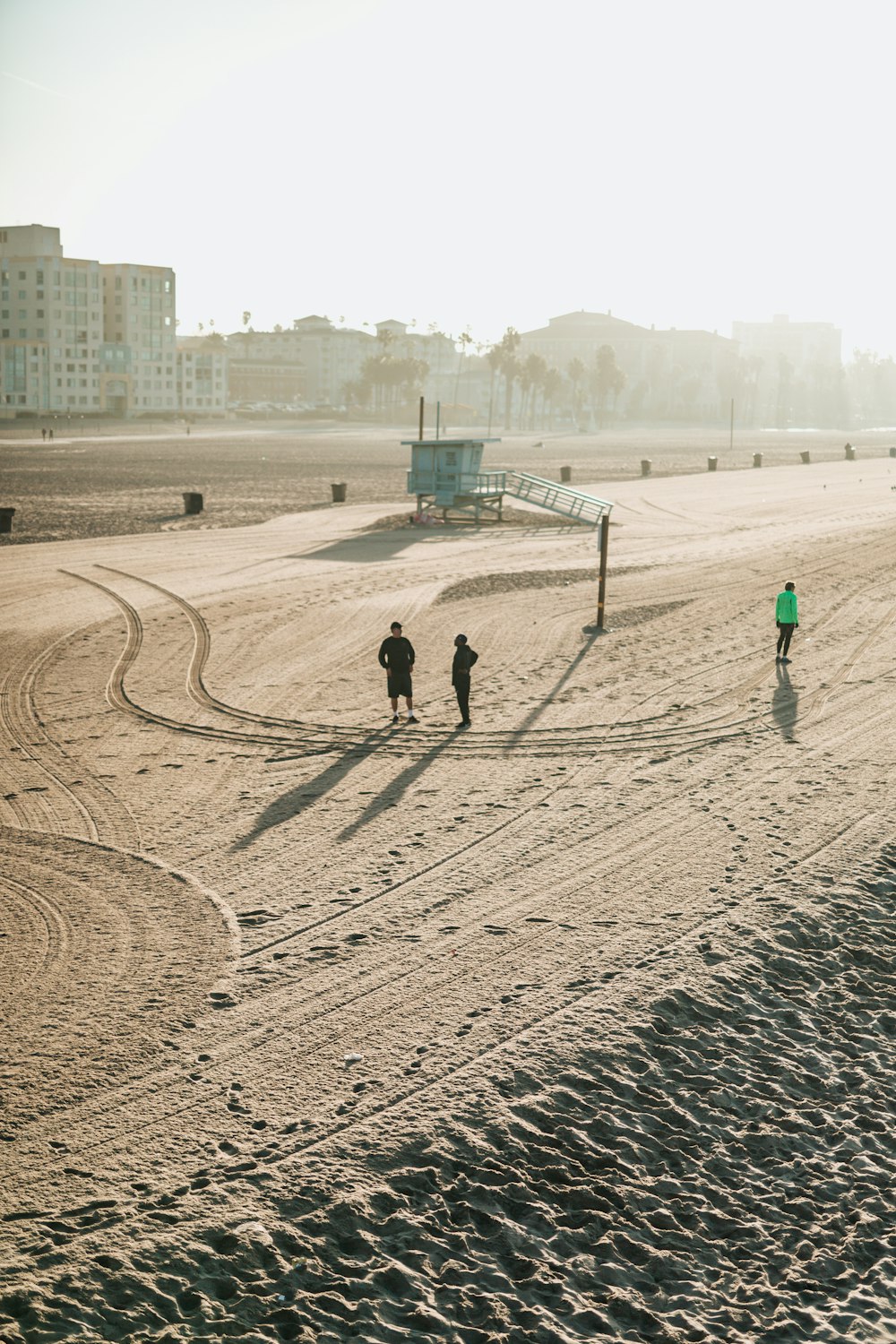 aerial photography of three people on shore