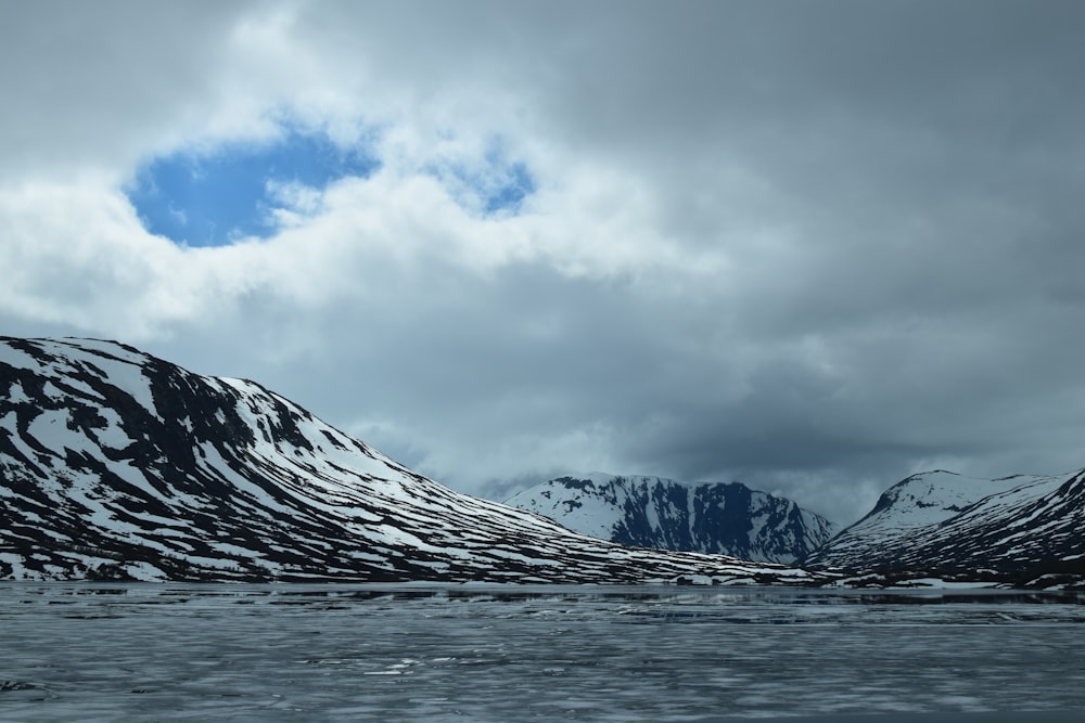 landscape of ocean and mountain covered with snow