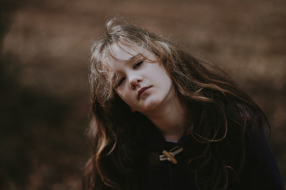 a young girl with long hair and a bow tie