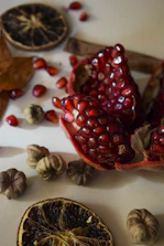 Close-up of premium dry fruits arranged elegantly on a dark green surface.